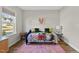 Bedroom with a window and a daybed with a colorful quilt at 110 Deacon Ridge Ln, Youngsville, NC 27596