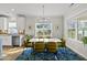 Bright dining area featuring a modern chandelier and ample natural light, ideal for Gathering meals and gatherings at 110 Deacon Ridge Ln, Youngsville, NC 27596