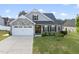 Charming two-story home featuring stone accents, a two-car garage, and a beautifully landscaped front yard at 110 Deacon Ridge Ln, Youngsville, NC 27596