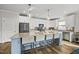 Modern kitchen featuring a large island with seating, stainless steel appliances, and custom white cabinets at 110 Deacon Ridge Ln, Youngsville, NC 27596