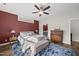 The bright primary bedroom features a large window, ceiling fan, and en suite at 110 Deacon Ridge Ln, Youngsville, NC 27596