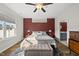 The bright primary bedroom features a large window, ceiling fan, and en suite at 110 Deacon Ridge Ln, Youngsville, NC 27596