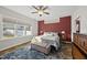 The bright primary bedroom features a large window, a ceiling fan, and neutral decor at 110 Deacon Ridge Ln, Youngsville, NC 27596
