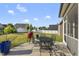 Cozy patio with seating area perfect for enjoying outdoor dining and relaxation with a leafy backyard at 110 Deacon Ridge Ln, Youngsville, NC 27596