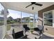 Relaxing screened porch with ceiling fan, wicker furniture, and views of the backyard at 110 Deacon Ridge Ln, Youngsville, NC 27596