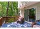 Relaxing back deck surrounded by lush trees with comfortable seating at 110 Ferris Wheel Ct, Cary, NC 27513