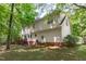 Back exterior of house with deck overlooking backyard and wooded area at 110 Ferris Wheel Ct, Cary, NC 27513