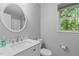 Bright bathroom featuring a single sink, marble countertops, and natural light from a window at 110 Ferris Wheel Ct, Cary, NC 27513