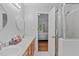 Bathroom with dual sinks, a shower with glass door, and view into the bedroom at 110 Ferris Wheel Ct, Cary, NC 27513