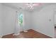 Light-filled bedroom showcasing hardwood floors and a window with sheer curtains at 110 Ferris Wheel Ct, Cary, NC 27513