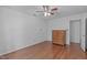 Well-lit bedroom boasts hardwood floors, a ceiling fan, and a classic wooden dresser at 110 Ferris Wheel Ct, Cary, NC 27513