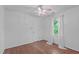 Cozy bedroom with hardwood floors, ceiling fan, and natural light streaming through a window at 110 Ferris Wheel Ct, Cary, NC 27513