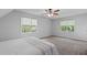 Spacious bedroom featuring carpet, two windows, and a serene, neutral color scheme at 110 Ferris Wheel Ct, Cary, NC 27513