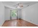 Inviting bedroom with hardwood flooring, ceiling fan, and a view to the outdoors at 110 Ferris Wheel Ct, Cary, NC 27513