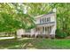 Charming two-story home with a welcoming front porch, lush landscaping, and attached garage at 110 Ferris Wheel Ct, Cary, NC 27513