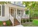 Inviting front porch with white railings, brick accents, and a cozy swing for relaxing outdoors at 110 Ferris Wheel Ct, Cary, NC 27513