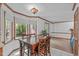 Bright eat-in kitchen area featuring a wooden dining table with views of the backyard at 110 Ferris Wheel Ct, Cary, NC 27513