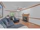 Cozy living room with a fireplace, hardwood floors, and a comfortable sectional sofa at 110 Ferris Wheel Ct, Cary, NC 27513