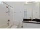 Bathroom with white tile, granite countertop, and combined tub and shower at 112 Glenspring Way, Morrisville, NC 27560