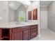 Bathroom vanity with marble countertop and a window view at 112 Glenspring Way, Morrisville, NC 27560
