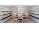 Large room with dining table set next to window and decorative shelving at 112 Glenspring Way, Morrisville, NC 27560