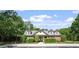 A charming community clubhouse with brick facade, dormer windows, and beautiful landscaping at 112 Glenspring Way, Morrisville, NC 27560