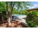 Community pool surrounded by lush greenery, trees, and comfortable seating areas for residents at 112 Glenspring Way, Morrisville, NC 27560