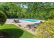 Outdoor community pool with lounge chairs, tables, and well-maintained surrounding landscape at 112 Glenspring Way, Morrisville, NC 27560