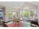 Sunlit dining room features large windows, an airy feel, and a comfortable nook perfect for relaxing at 112 Glenspring Way, Morrisville, NC 27560