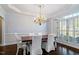 Elegant dining room featuring a chandelier, wainscoting, and bright natural light at 112 Glenspring Way, Morrisville, NC 27560