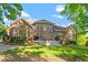 Rear exterior view of a brick home with a large deck and well-maintained yard at 112 Glenspring Way, Morrisville, NC 27560