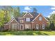 Charming two-story brick home with a manicured lawn and mature trees at 112 Glenspring Way, Morrisville, NC 27560