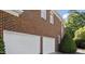Spacious two-car garage with white doors, offering ample parking and storage space at 112 Glenspring Way, Morrisville, NC 27560
