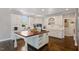 Bright kitchen features white cabinetry, hardwood floors, and large center island perfect for food preparation at 112 Glenspring Way, Morrisville, NC 27560