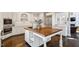 Charming kitchen featuring white cabinets, wood floors and a central island at 112 Glenspring Way, Morrisville, NC 27560
