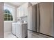 Efficient laundry room with stainless steel appliances and ample storage space for household needs at 112 Glenspring Way, Morrisville, NC 27560