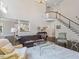 Bright living room with high ceilings, large windows, and a beautiful staircase at 112 Glenspring Way, Morrisville, NC 27560