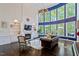 Light filled living room boasts a fireplace, built-ins, and soaring windows at 112 Glenspring Way, Morrisville, NC 27560