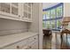Bright butler's pantry with marble countertops, custom cabinetry, and hardwood floors at 112 Glenspring Way, Morrisville, NC 27560