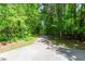 Picturesque paved walking path through a serene wooded area at 112 Glenspring Way, Morrisville, NC 27560