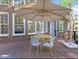 Cozy outdoor patio with a table, chairs, and large umbrella for shade at 112 Glenspring Way, Morrisville, NC 27560