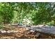 Community playground with slides, climbing equipment, and seating area surrounded by mature trees at 112 Glenspring Way, Morrisville, NC 27560