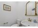 A powder room featuring a decorative mirror, decorative faucet, and classic white fixtures at 112 Glenspring Way, Morrisville, NC 27560