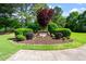 Community entrance sign with landscaping and well-manicured shrubs at 112 Glenspring Way, Morrisville, NC 27560
