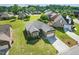 Aerial view of brick home on verdant, well-kept lawn in a quiet neighborhood setting at 116 Colonade Ct, Benson, NC 27504