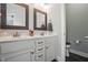 Bathroom with double sink vanity, framed mirrors, granite countertop, and gray walls at 116 Colonade Ct, Benson, NC 27504