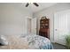 Bedroom with ceiling fan, grey walls, wood floor, large door and china cabinet at 116 Colonade Ct, Benson, NC 27504