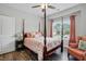Primary bedroom with four poster bed, wood floor, ceiling fan, window and bedside table at 116 Colonade Ct, Benson, NC 27504