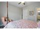 Bedroom with pink bedspread, wood floor, ceiling fan, white walls and a pink chair at 116 Colonade Ct, Benson, NC 27504