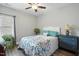 Bedroom with ceiling fan, grey walls, wood floor, and large window with shades at 116 Colonade Ct, Benson, NC 27504